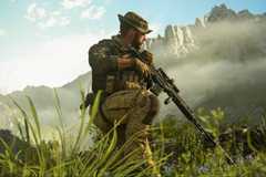 Captain Price crouches in tall grass in an open-world campaign mission in Call of Duty: Modern Warfare 3